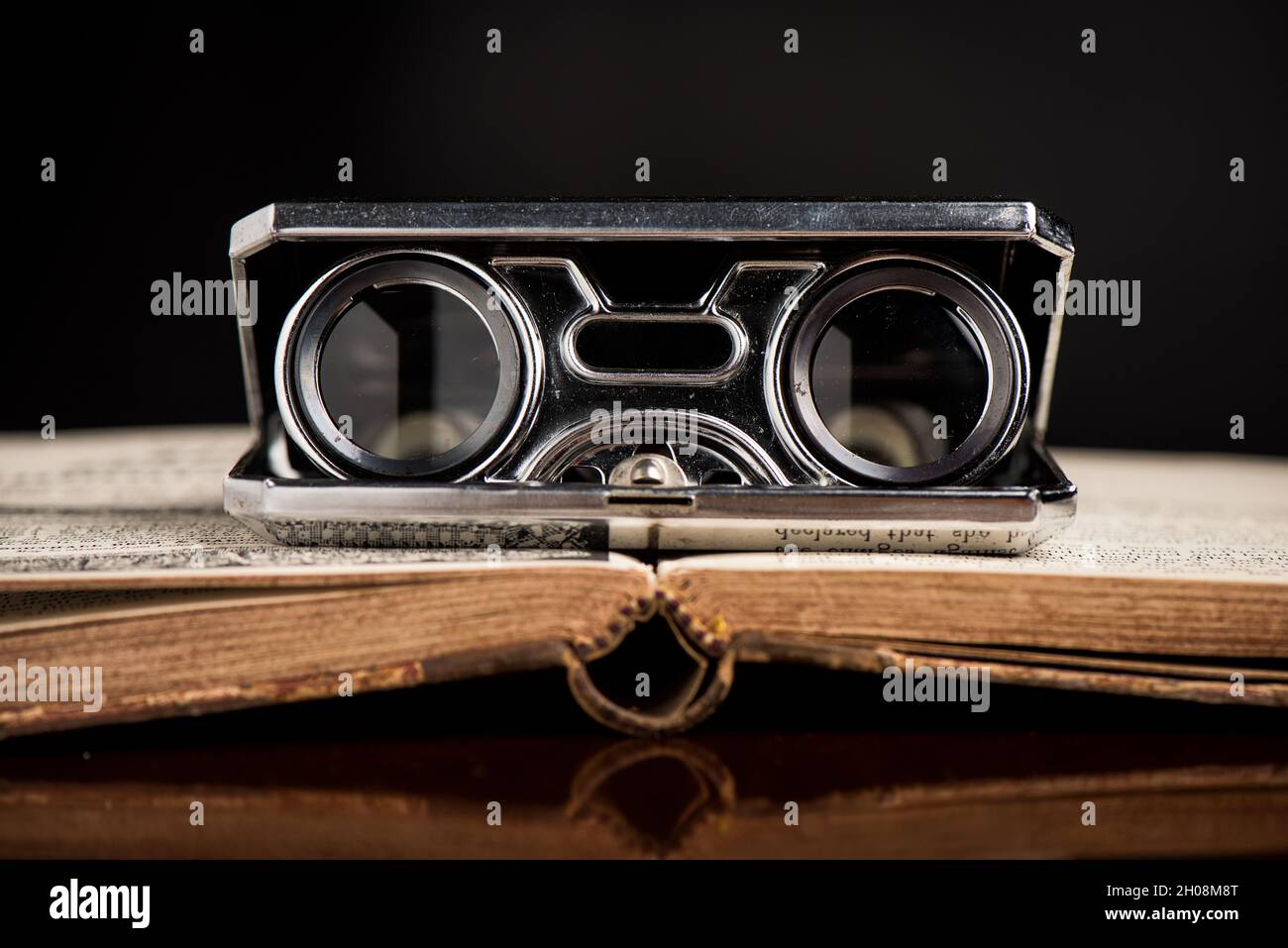 Closeup vintage folding opera glasses. Old compact binoculars Stock