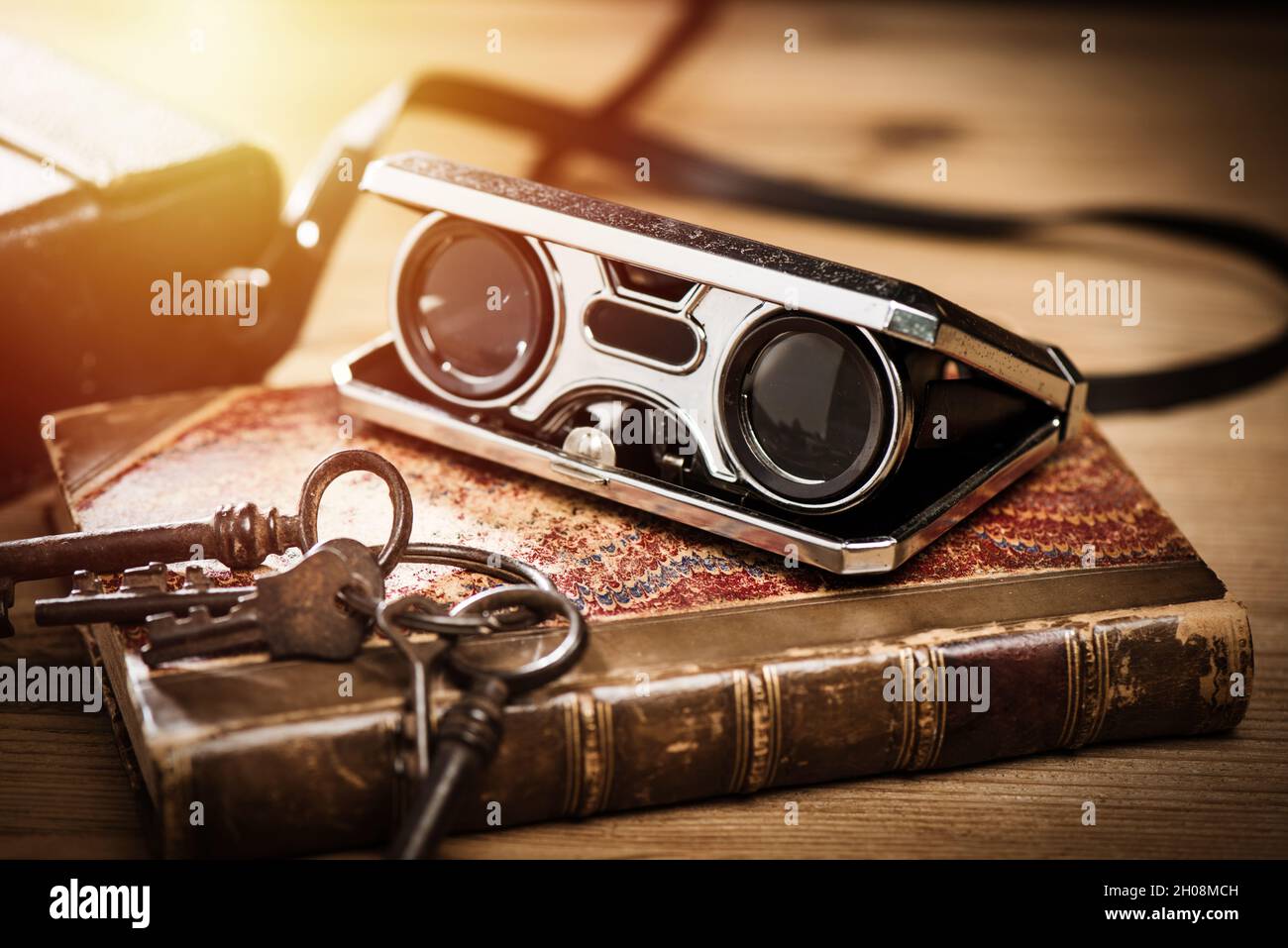 Closeup vintage folding opera glasses. Old compact binoculars Stock