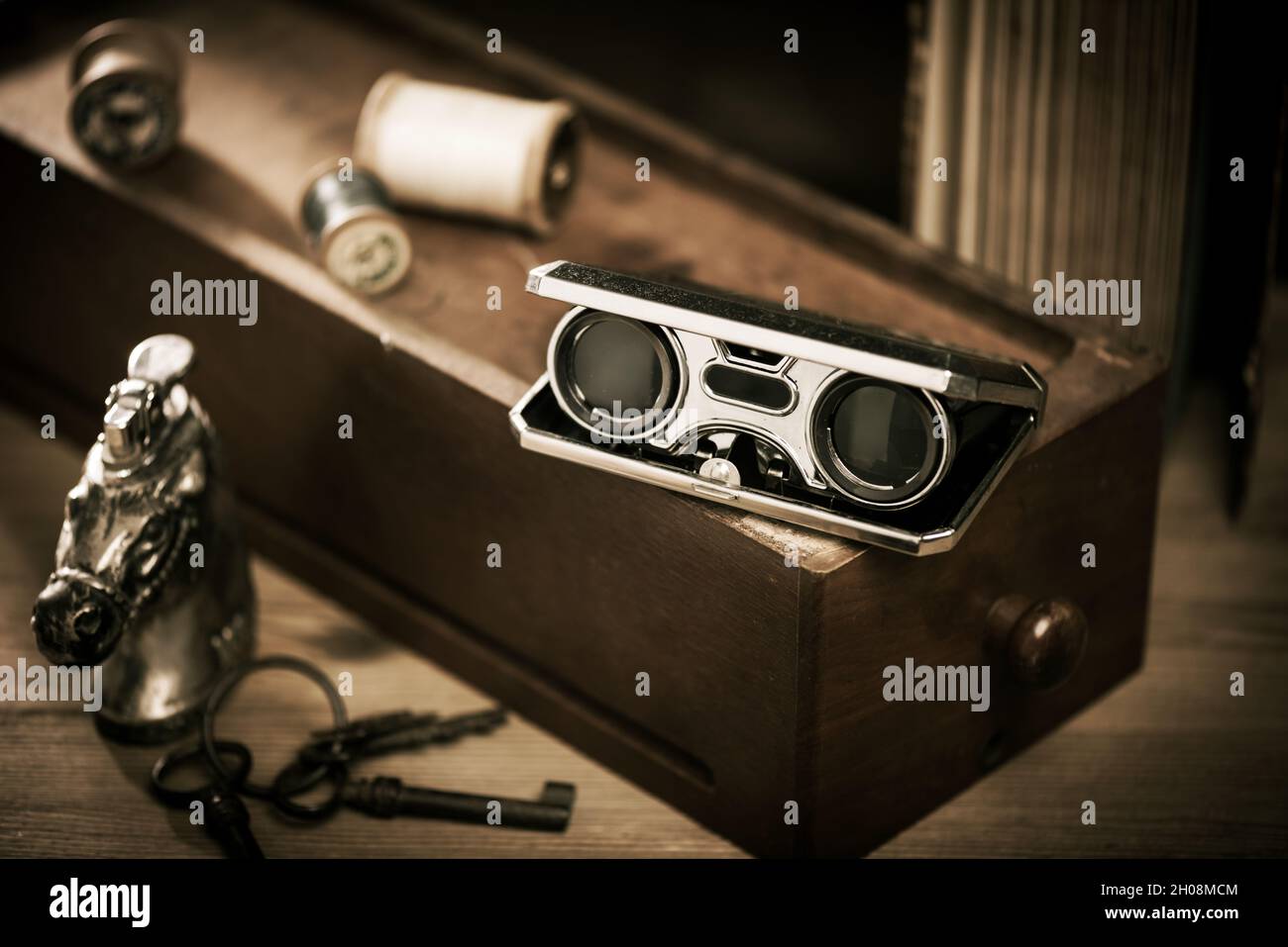 Closeup vintage folding opera glasses. Old compact binoculars Stock