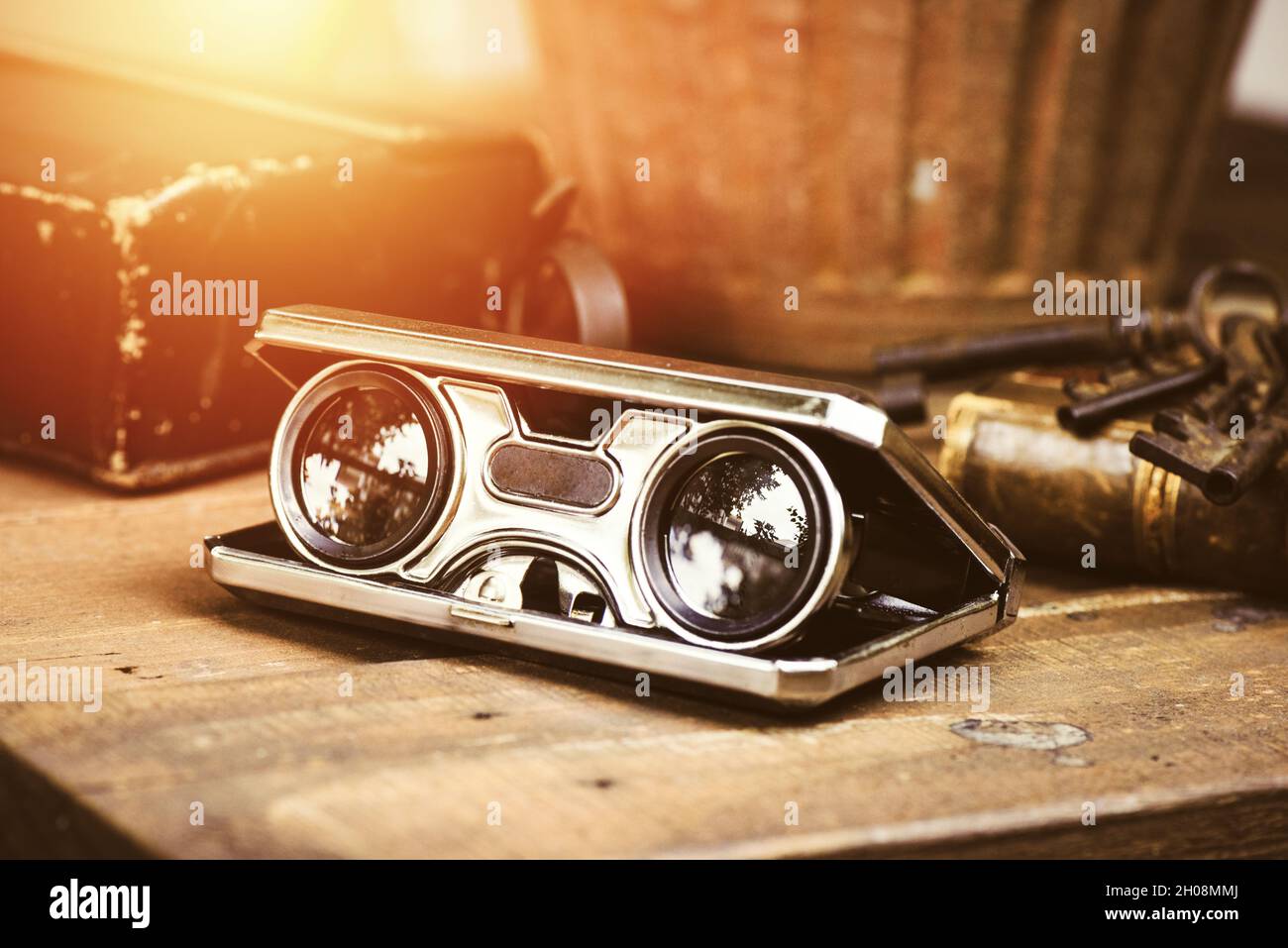 Closeup vintage folding opera glasses. Old compact binoculars. Stock Photo