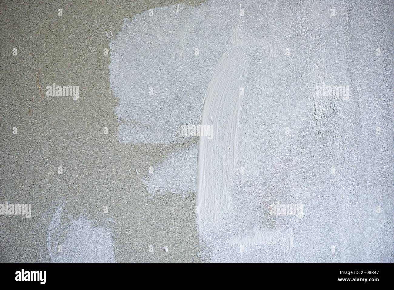 Painted wall background, Painter painting a house wall with a paint poller Stock Photo