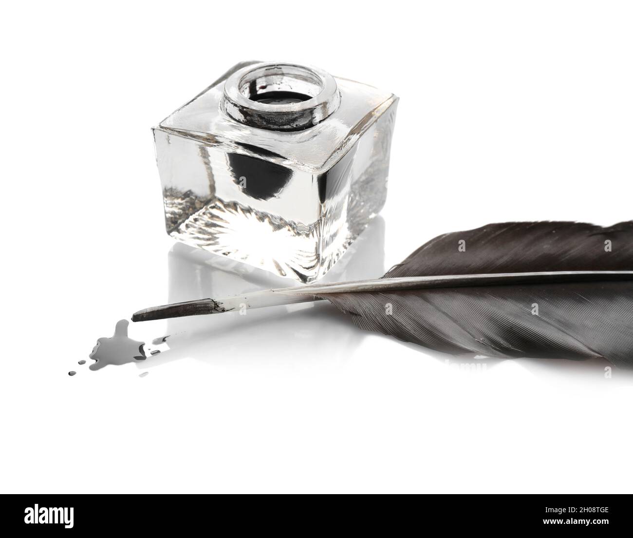 Feather pen and inkwell on white background Stock Photo - Alamy
