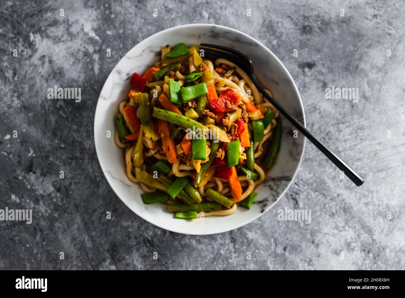 vegan mixed vegetables stir fry with udon noodles, healthy plantbased food recipes Stock Photo