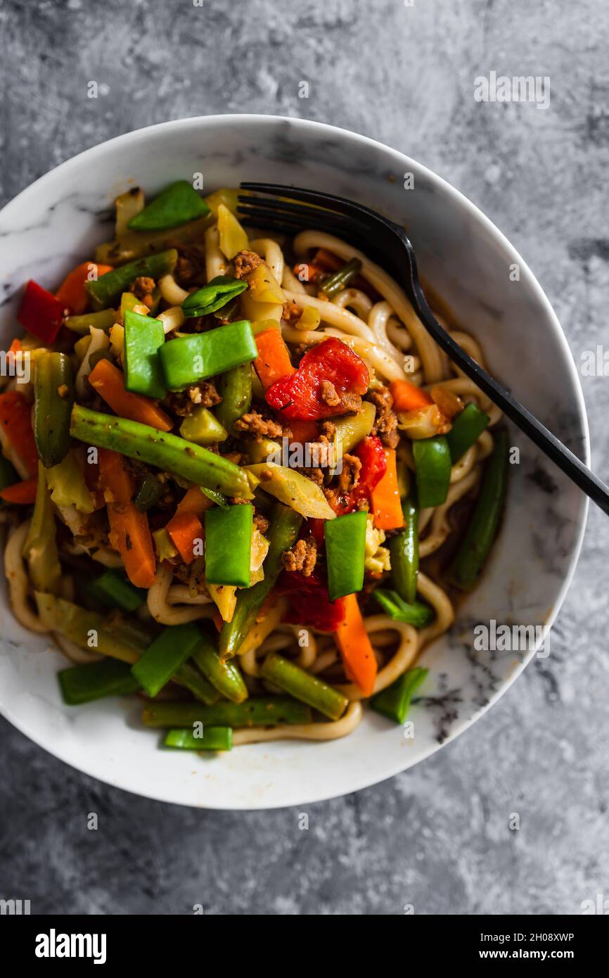 vegan mixed vegetables stir fry with udon noodles, healthy plantbased food recipes Stock Photo