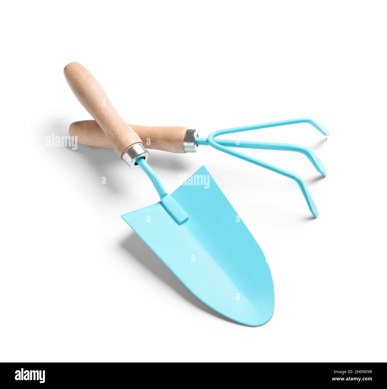 Trowel And Rake New rake and trowel on white background. Professional gardening tools ...