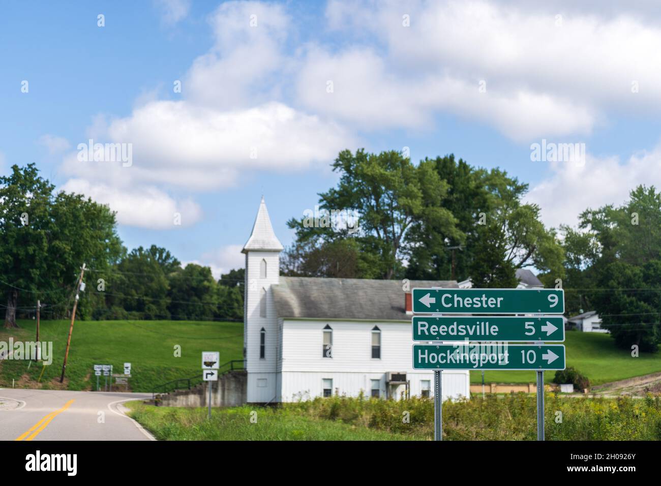 Rural Ohio landscape with road signs for Chester, Reedsville, and