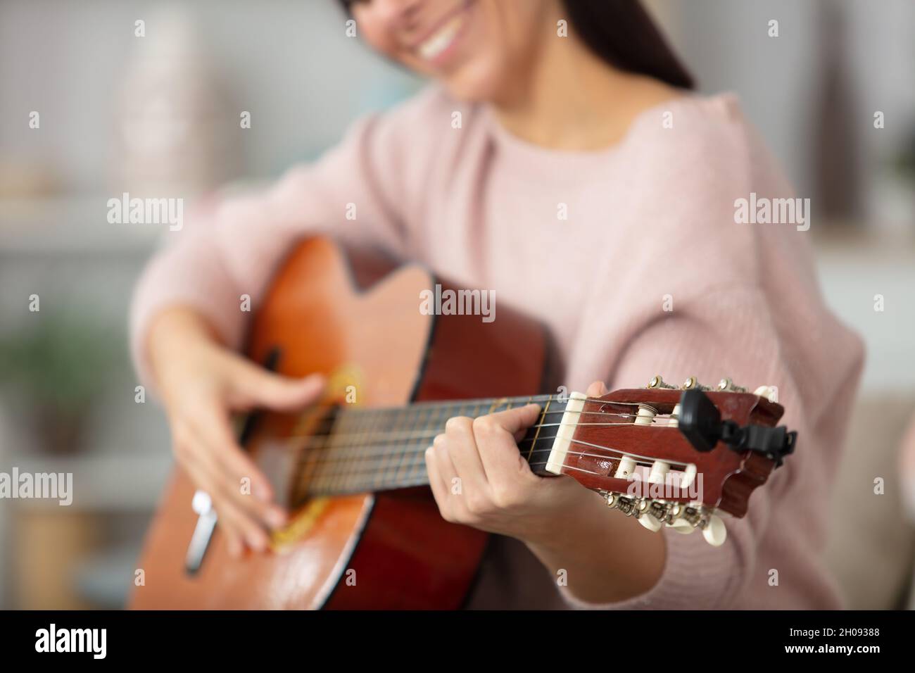 teenage girl playing an acoustic guitar Stock Photo - Alamy