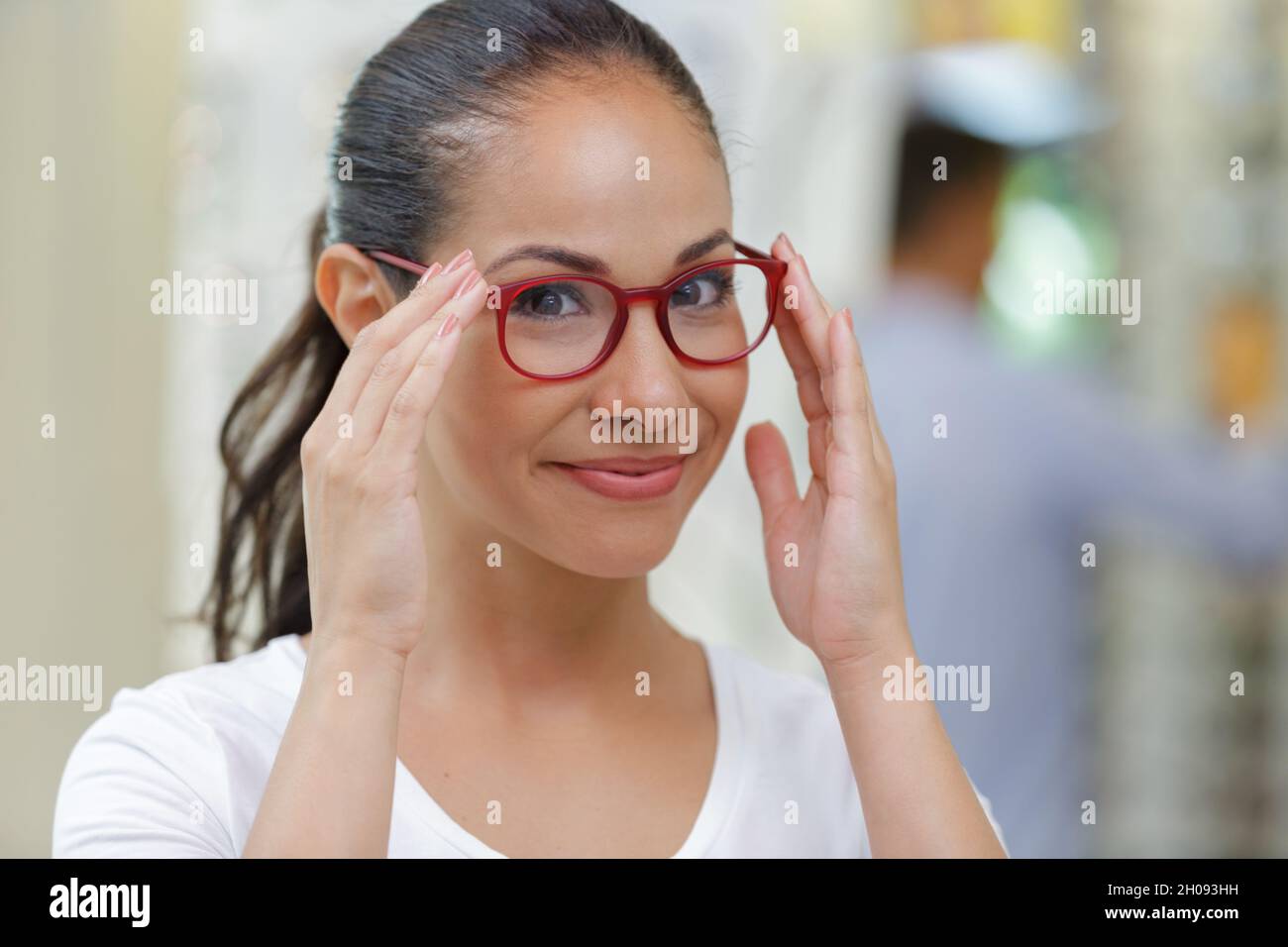 woman buys glasses in an optic store Stock Photo