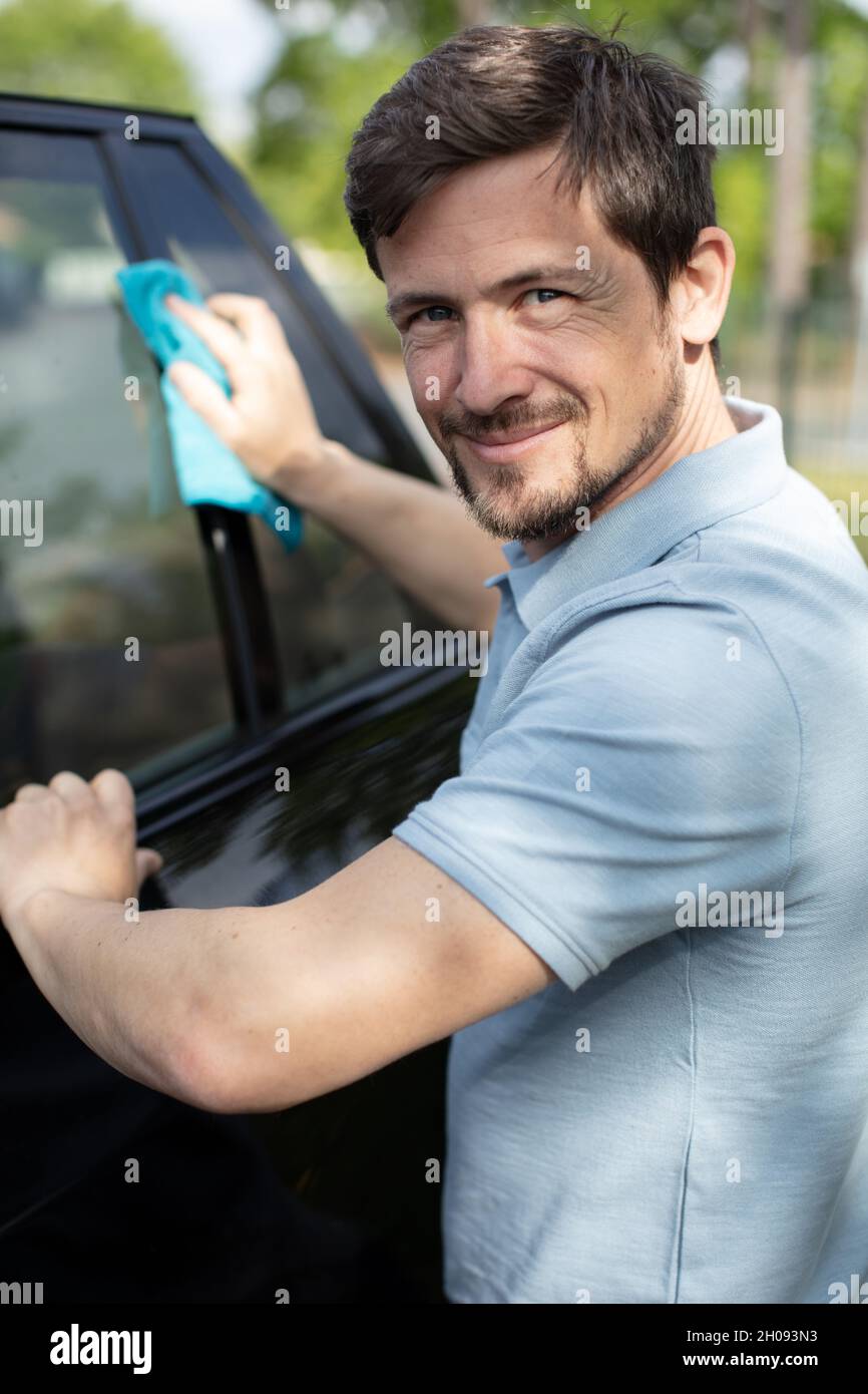 man cleaning car exterior with a cloth Stock Photo Alamy