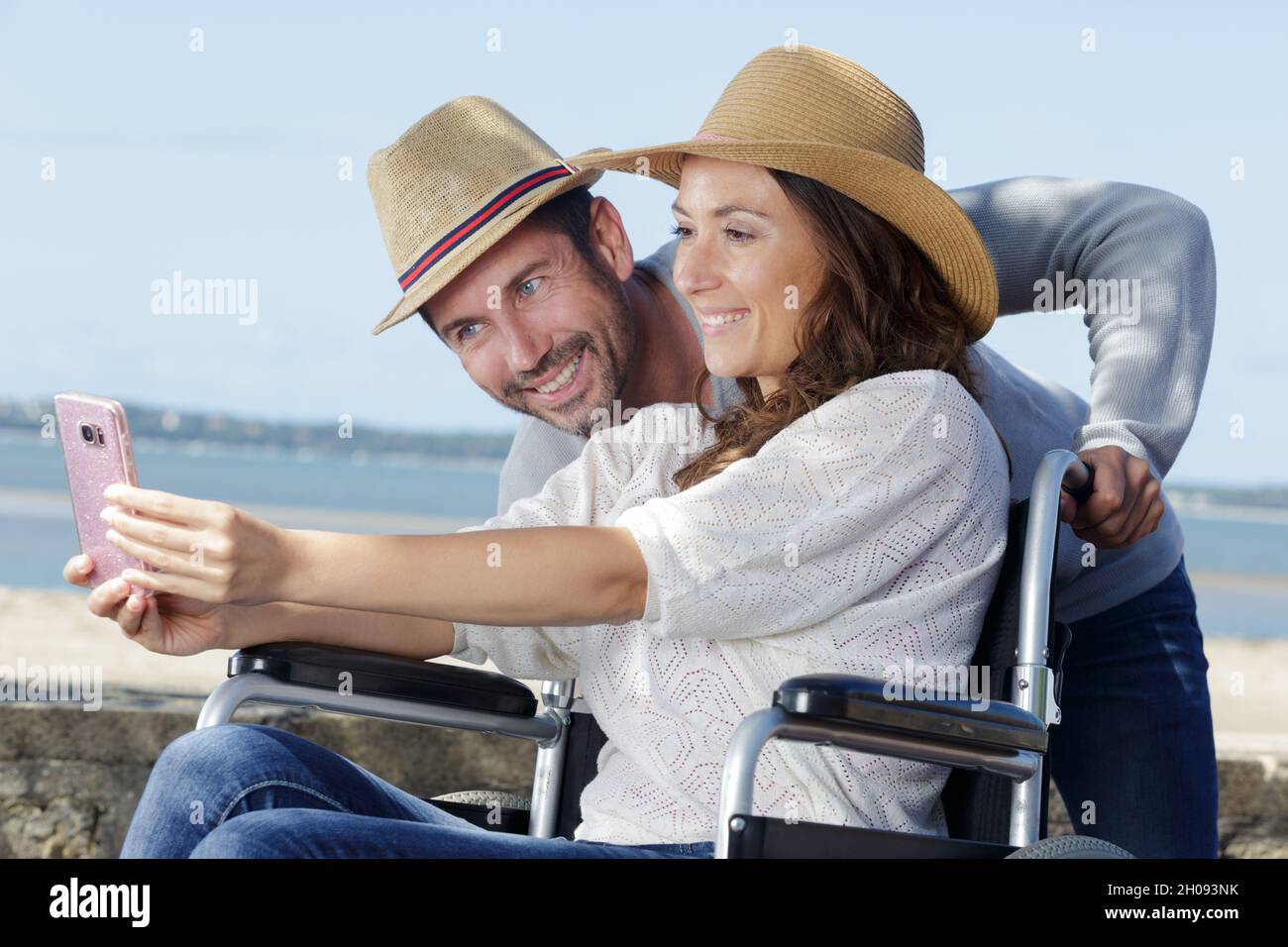woman in wheelchair and her husband taking selfie outdoors Stock Photo ...
