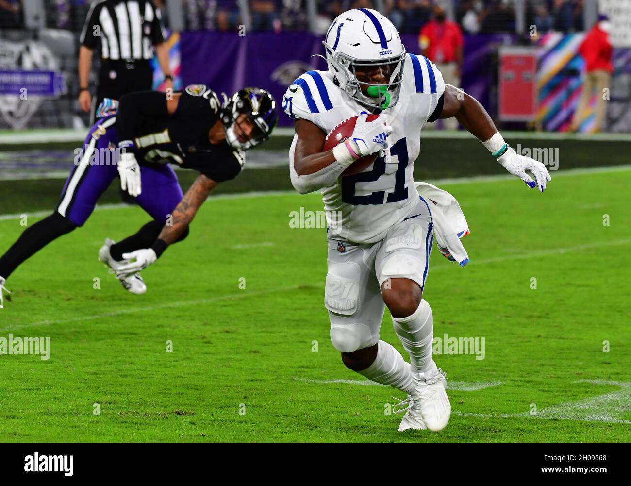 Baltimore, United States. 11th Oct, 2021. Indianapolis Colts running back Nyheim Hines (21) runs past Baltimore Ravens' Tylan Wallace (16) during the first half at M&T Bank Stadium in Baltimore, Maryland, on Monday, October 11, 2021. Photo by David Tulis/UPI Credit: UPI/Alamy Live News Stock Photo