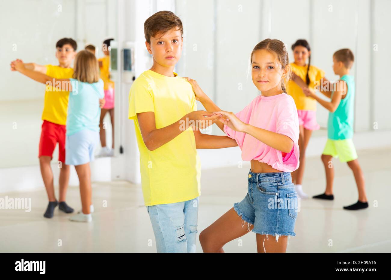 Group of kids dancing salsa in studio Stock Photo - Alamy