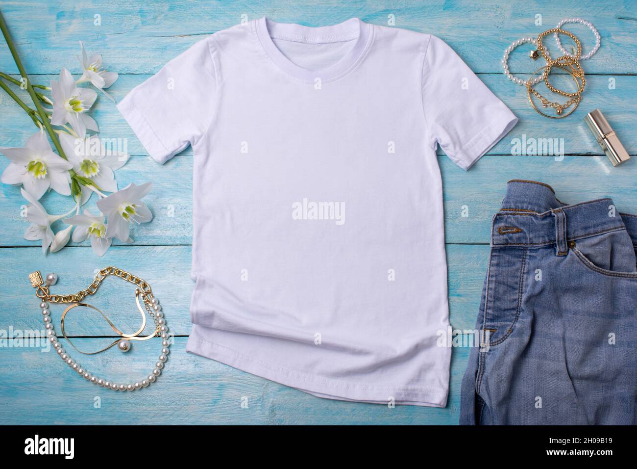 White womens cotton T-shirt mockup with white lilies, necklace and lipstick. Design t shirt template, tee print presentation mock up Stock Photo