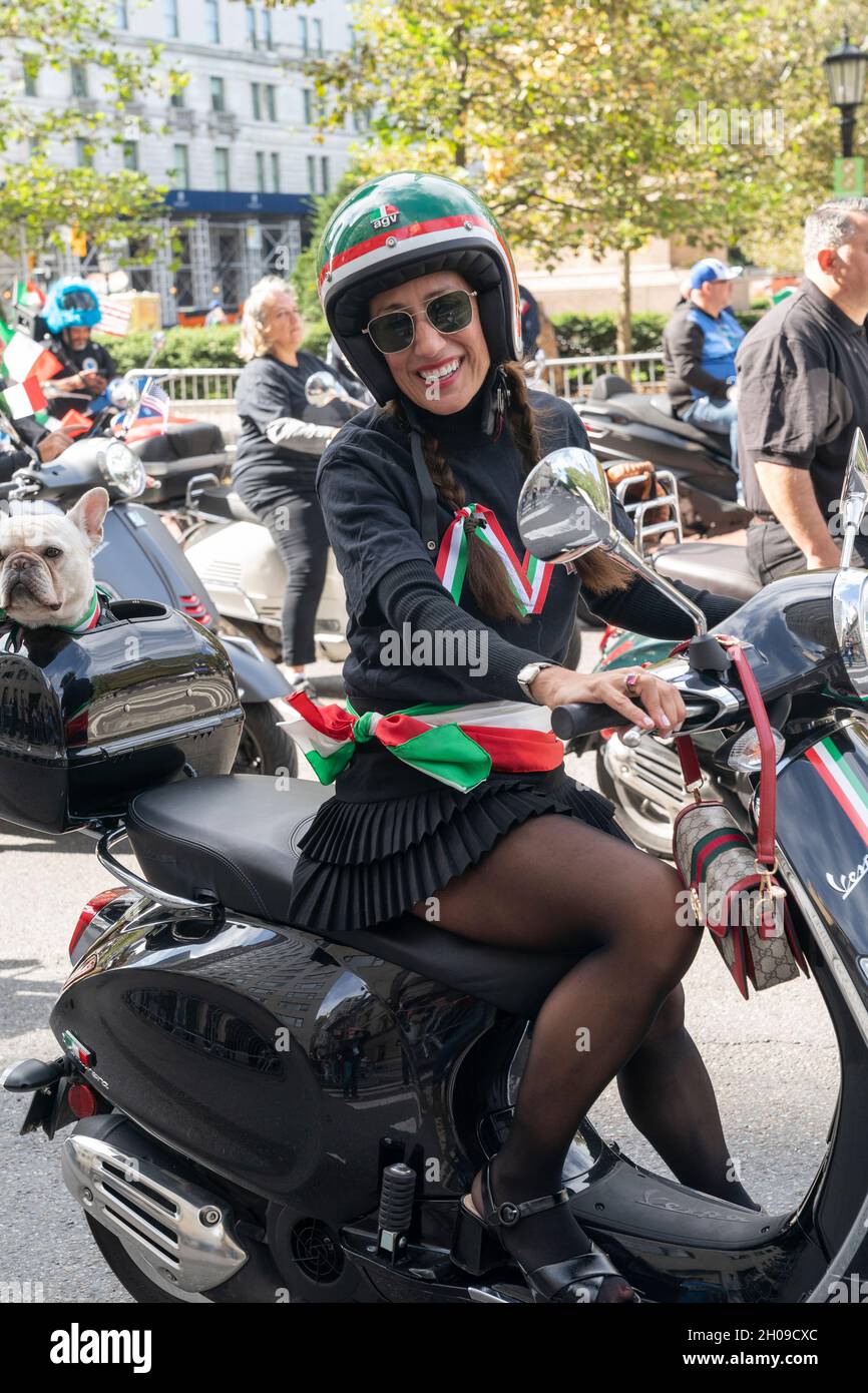 New York, NY October 11, 2021 A woman drives Vespa motorroller