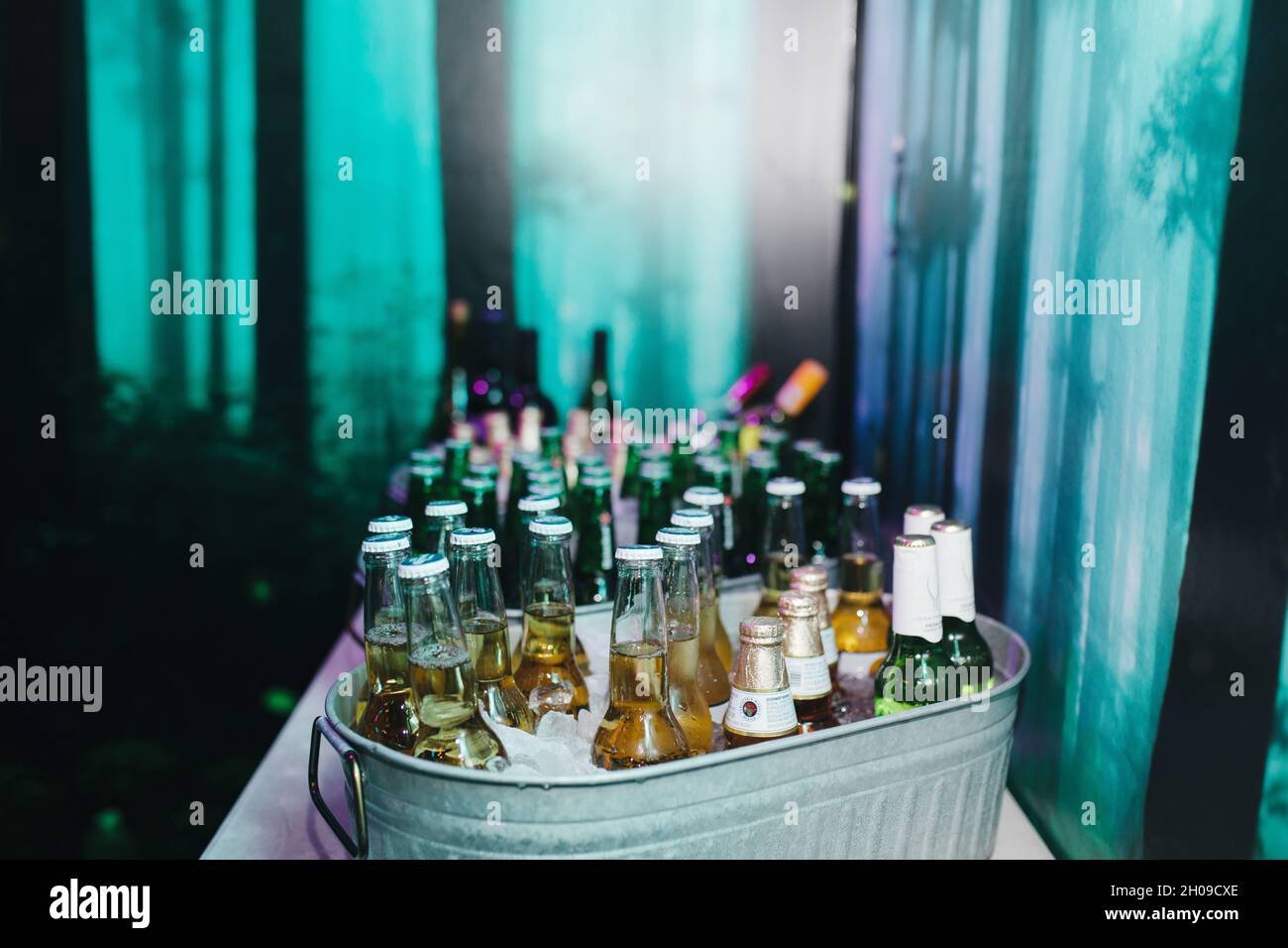 arrangement of beers on ice in metal cooler at night club Stock Photo