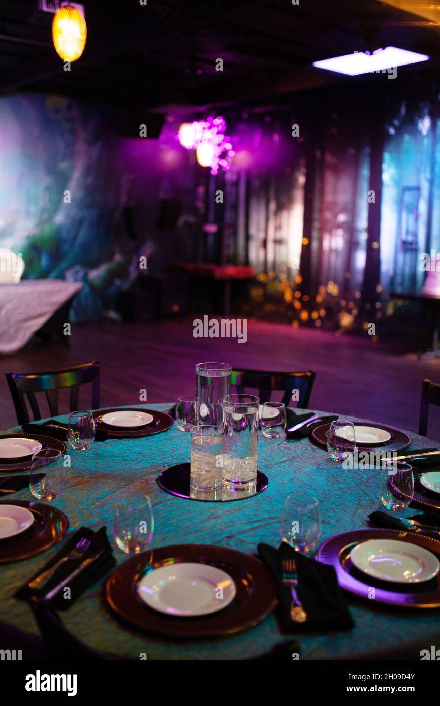 Wedding venue - green and purple restaurant hall, with neon lighting, white  three tiered cake Stock Photo - Alamy, image size:866x1390