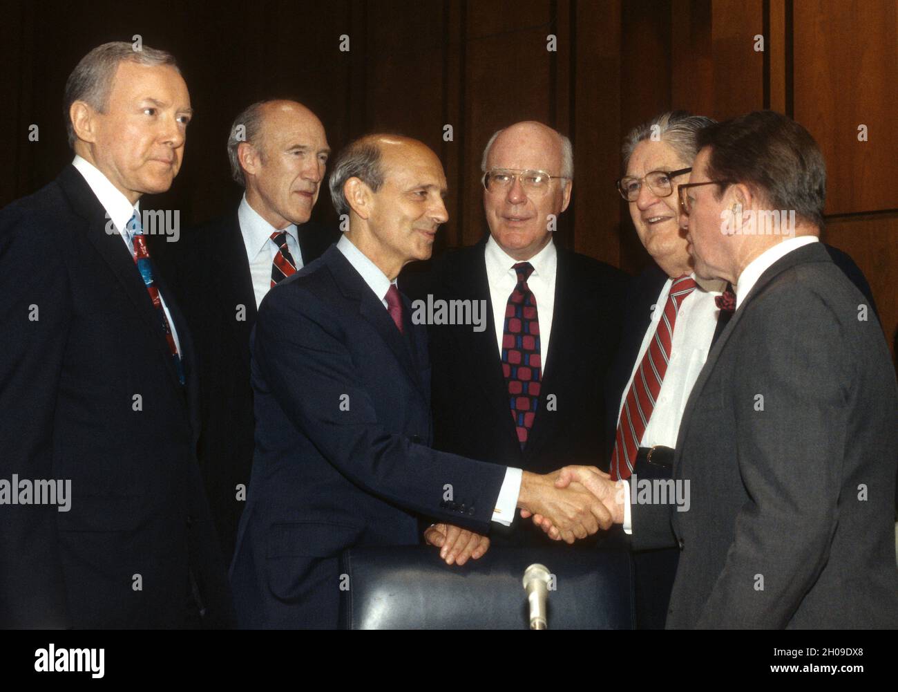 United States Senator Paul Simon (Democrat of Illinois), right, welcomes Chief Judge of the US Court of Appeals for the First Circuit, Stephen G. Breyer, US President Bill Clinton’s nominee to replace the retiring Justice Harry Blackmun as Associate Justice of the US Supreme Court, third left, to his confirmation hearing on Capitol Hill in Washington, DC on July 12, 1994.  From left to right; US Senator Orrin Hatch (Republican of Utah), US Senator Alan Simpson (Republican of Wyoming), Judge Breyer, United States Senator Patrick Leahy (Democrat of Vermont), US Senator Howell Heflin (Democrat of Stock Photo