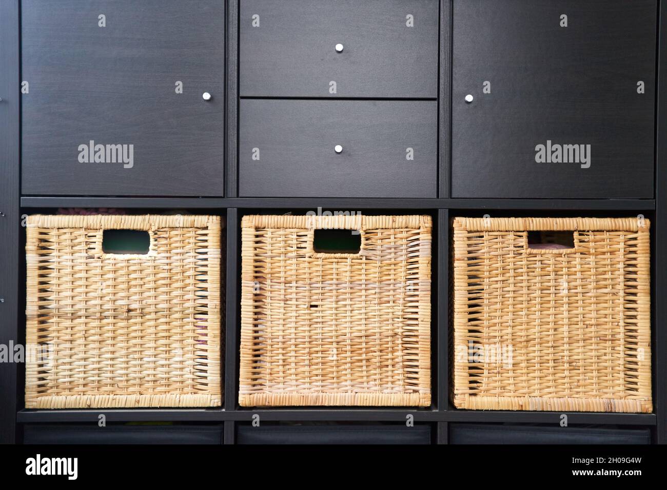 Wicker boxes for things on the shelves. Wardrobe for storage of things Stock Photo