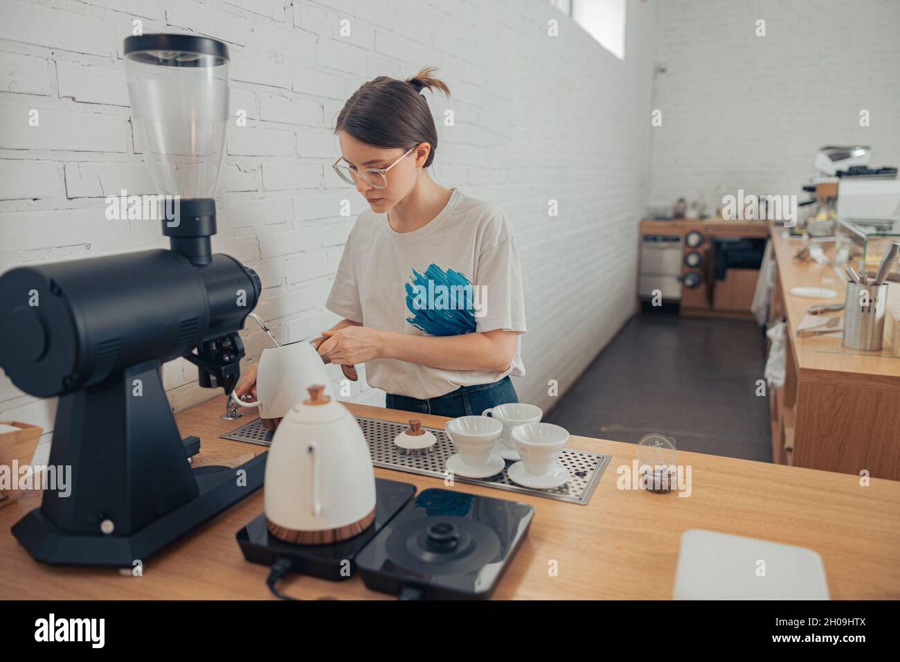 Nice female barista making coffee in cafeteria Stock Photo Alamy