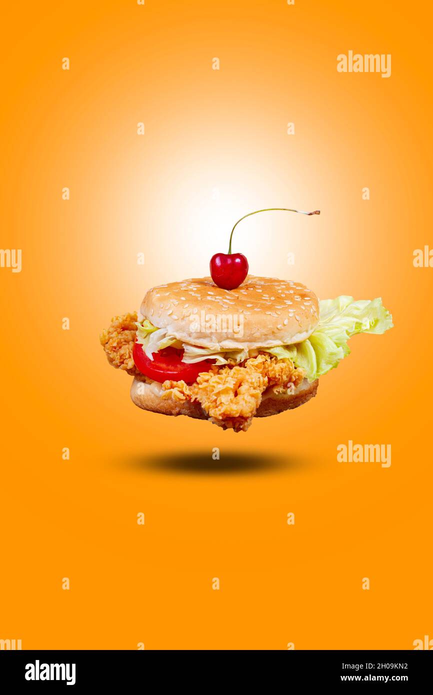 Juicy flying fish burger, hamburger or cheeseburger with one fish patties. Concept of American fast food. Copy space Stock Photo