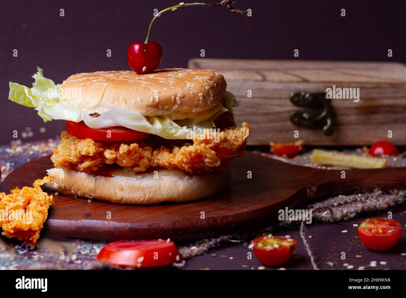 Juicy fish burger, hamburger or cheeseburger with one fish patties, with sauce. Concept of American fast food. Copy space Stock Photo