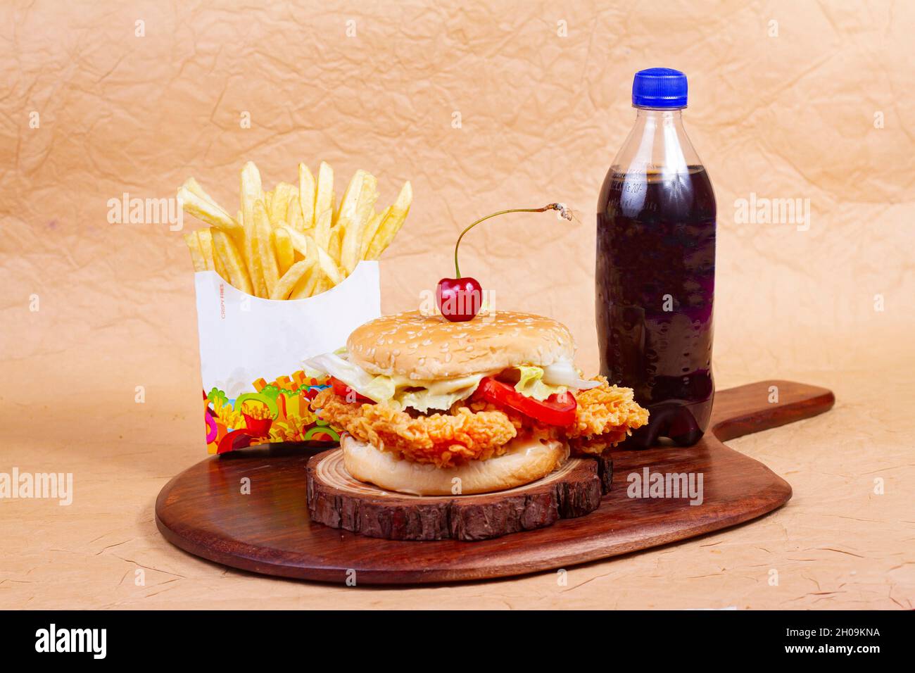 Juicy fish burger, hamburger or cheeseburger with one fish patties, with sauce french fries and cold drink. Concept of American fast food. Copy space Stock Photo