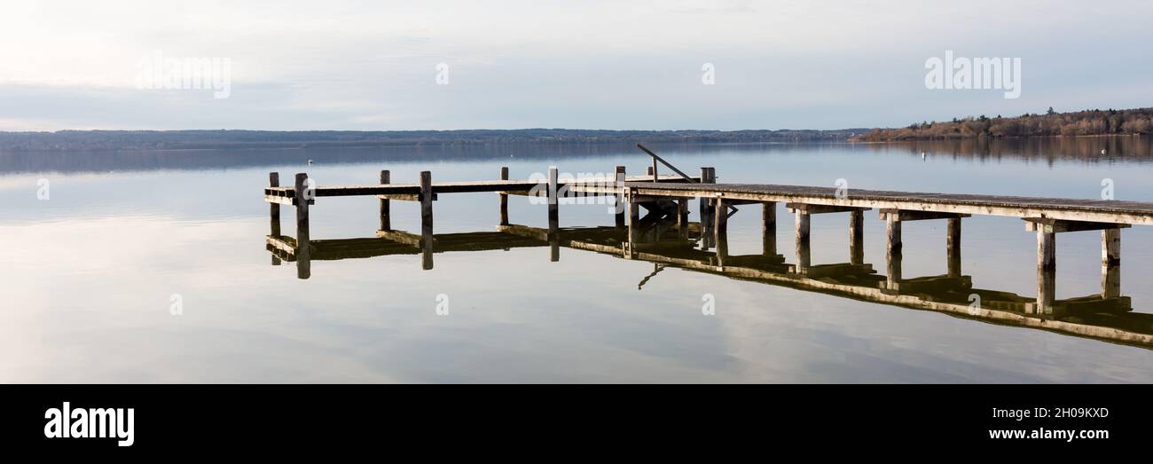 Panorama of Ammersee. Beautiful lake with wooden pier. Popular sightseeing destination. Stock Photo
