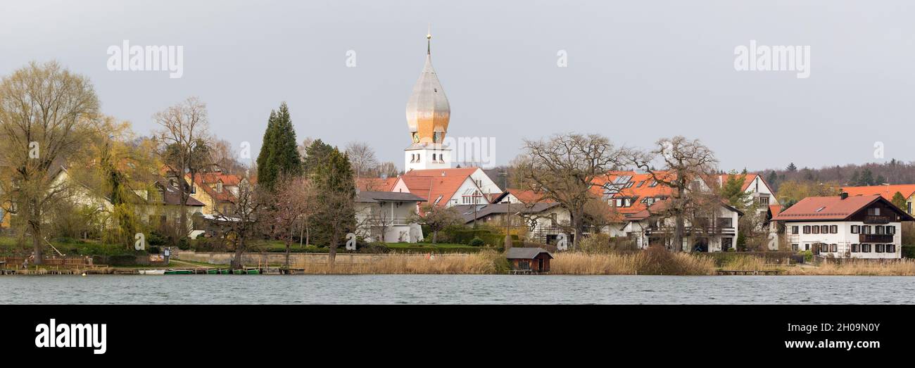 Weßling, Germany - Apr 19, 2021: Panorama of Weßling. With church 'Christkönig', lake and residential buildings. Popular sightseeing spot near Munich. Stock Photo