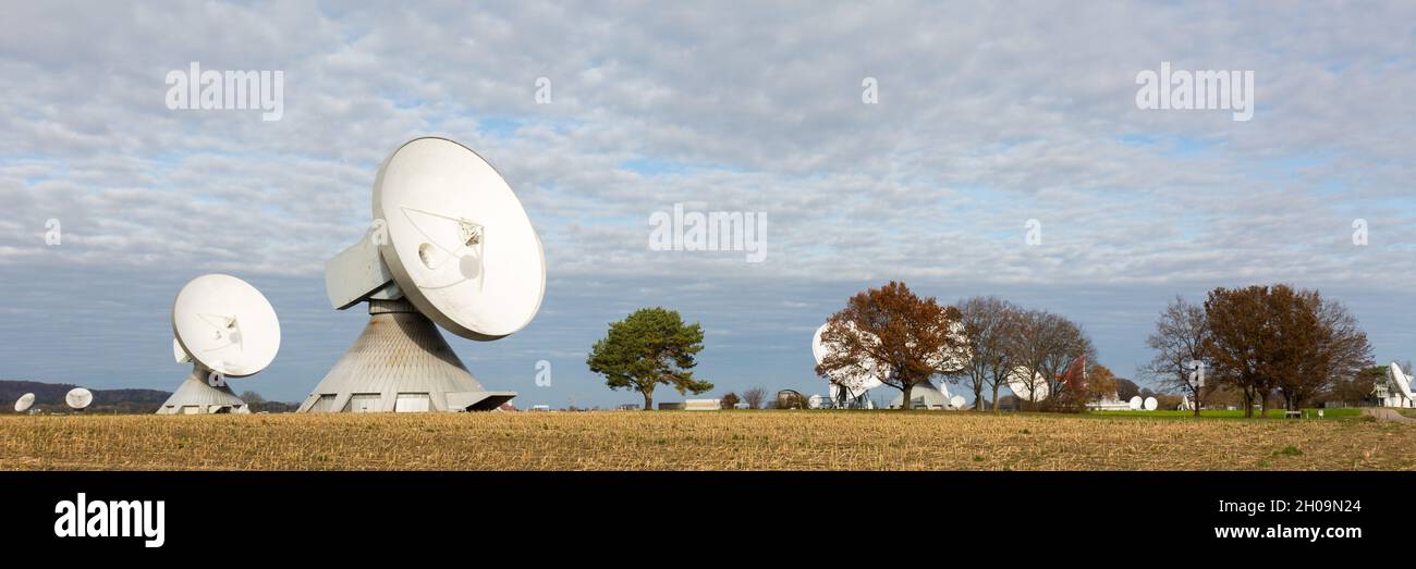 Raisting, Germany - Nov 13, 2020: Panorama with several satellite dishes and trees. Bavarian landscape at the Raisting Radome. Stock Photo