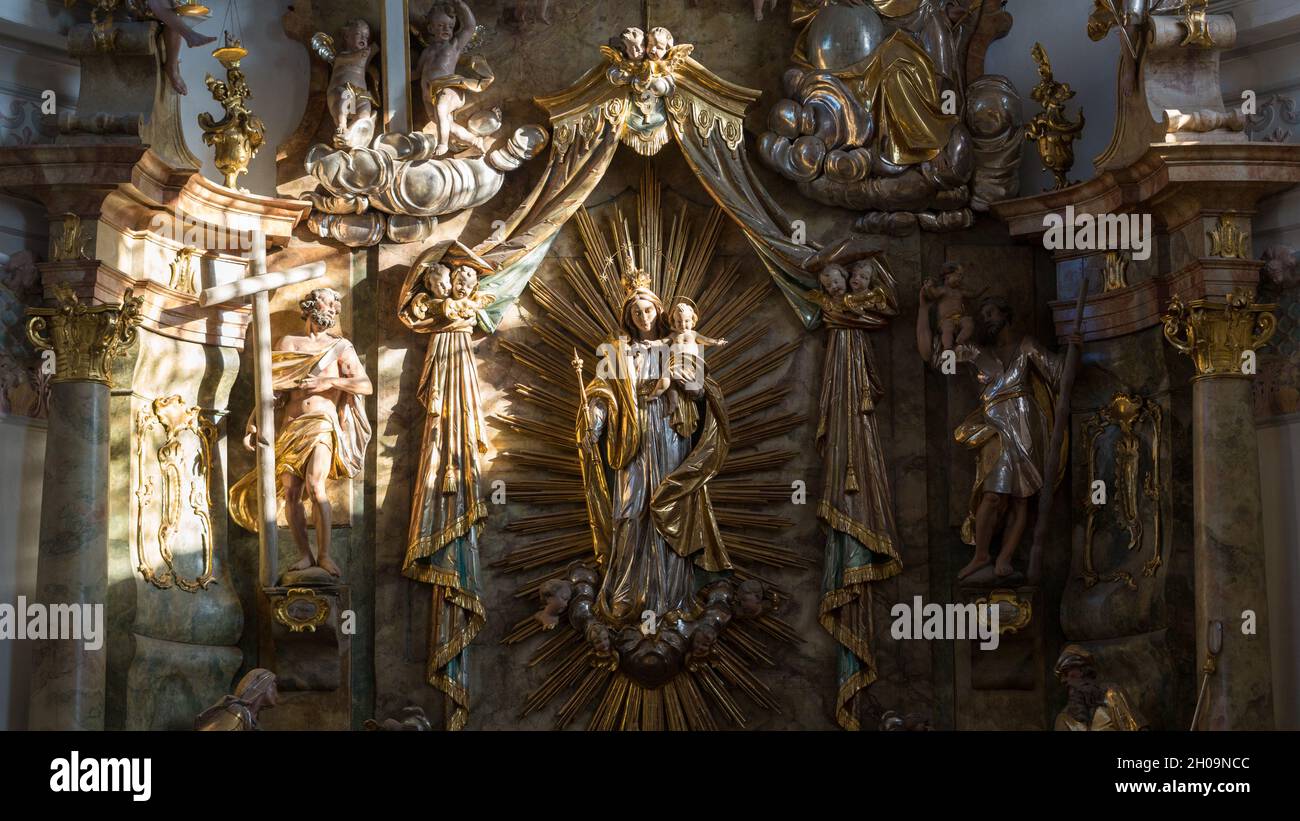 Altomünster, Germany - Nov 18, 2020: Religious sculptures illuminated by a sunray. With mary and her child Jesus. Stock Photo