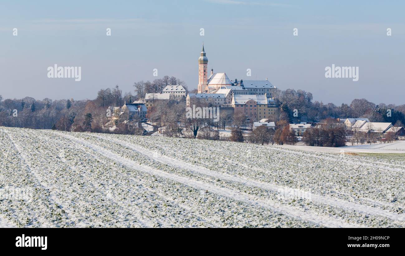 Andechs, Germany - Dec 3, 2020: Bavarian winter landscape with snow-covered fields and Kloster Andechs (Andechs abbey). Stock Photo