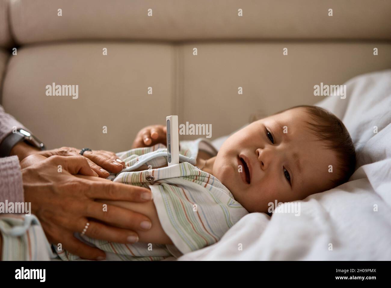 The little boy cry because of the high temperature. First year of life