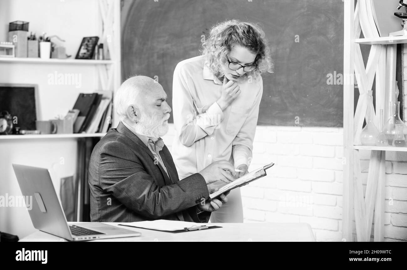 Tutor Man School project. student girl with tutor man at blackboard. pass exam ...