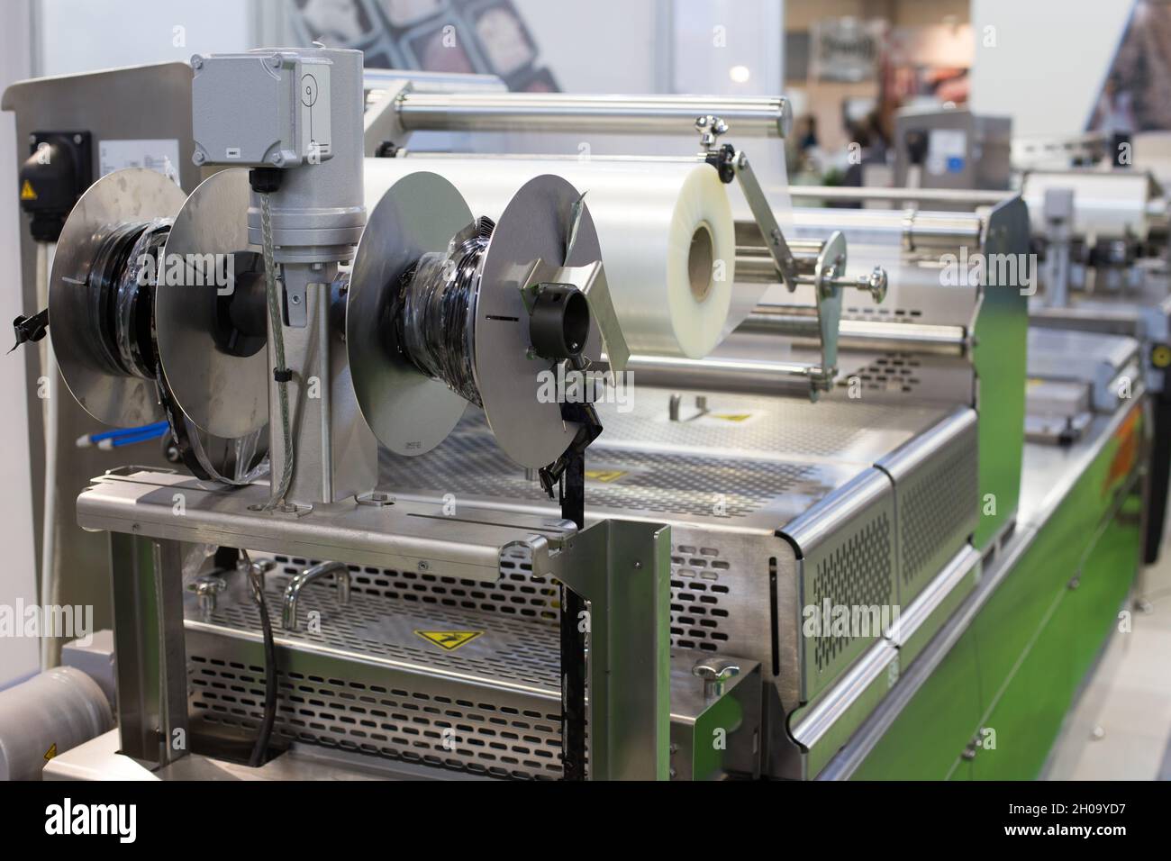 Stretched foil on packaging machine in food industry Stock Photo
