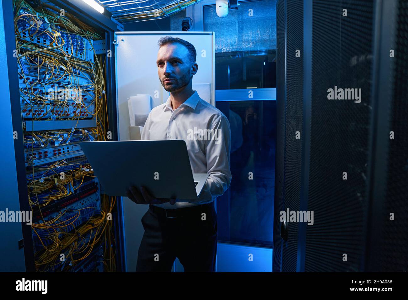 Server administrator doing network maintenance in data center Stock Photo