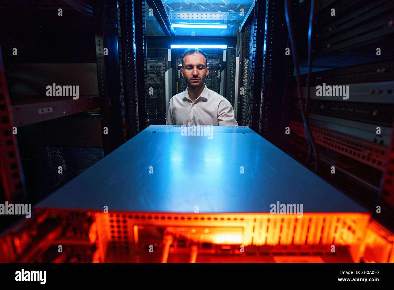 Data center worker doing maintenance of computer equipment Stock Photo