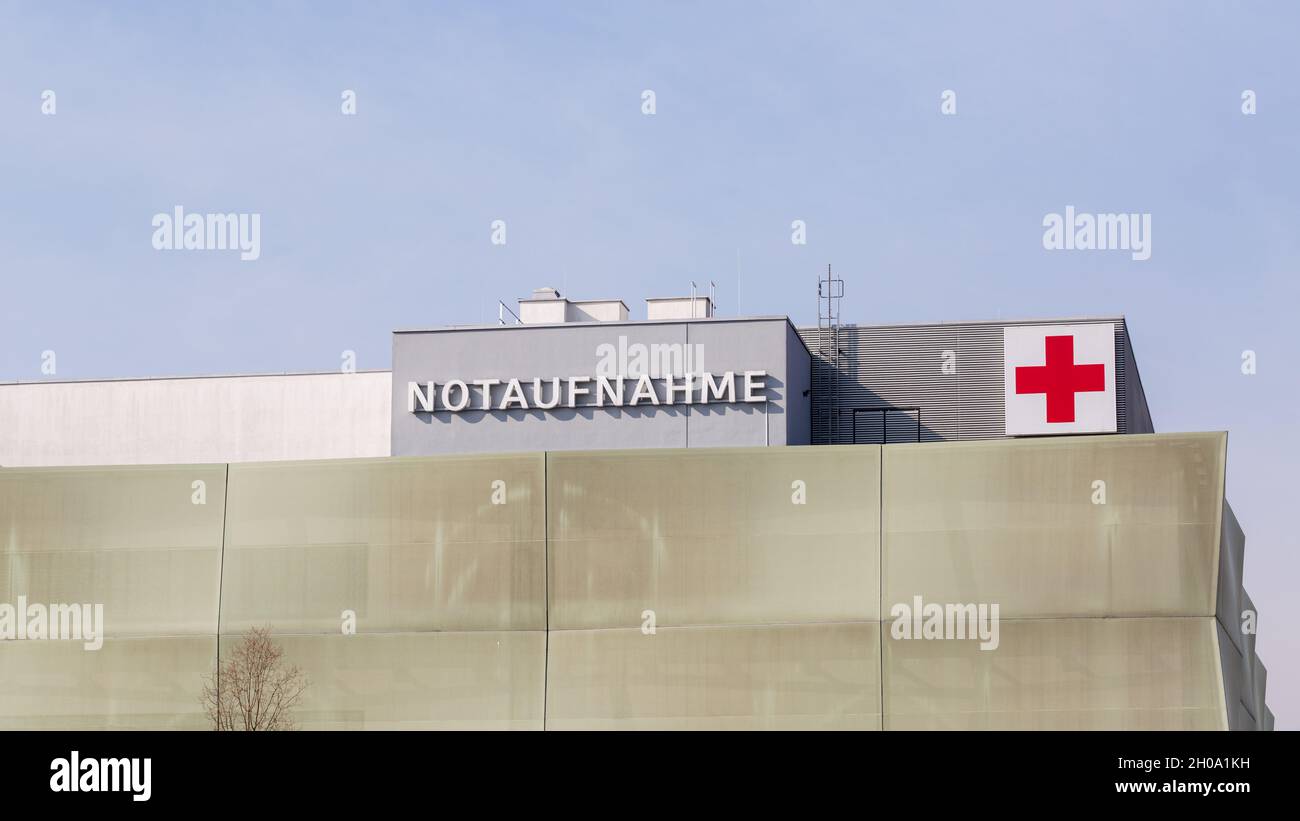 Munich, Großhadern, Germany - Mar 9, 2021: Writing Notaufnahme (Emergency Room) with red cross. At the facade of Klinikum Großhadern (hospital). Stock Photo