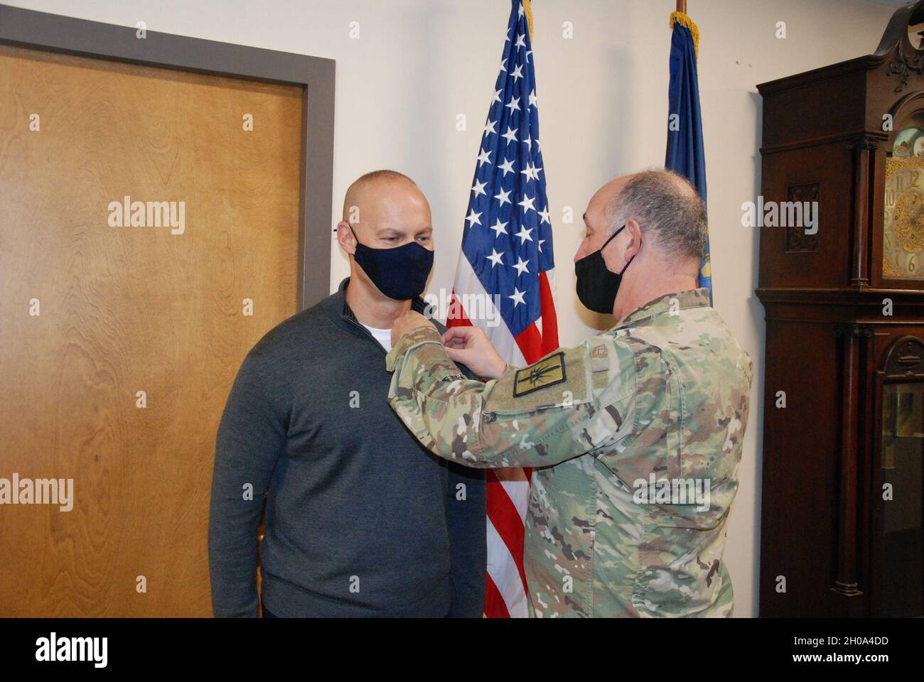 Retired New York Army National Guard Captain Kenneth Bombace, a Holbrook, New York resident, receives the Combat Action Badge from Col. Richard Goldenberg during a short ceremony held on Jan. 4, 2020 at New York Army National Guard headquarters in Latham, New York. Bombace was recognized for his involvement in an action which took place during a firefight in Samarra, Iraq on May 21, 2005 when he was assigned to the 642nd Military Intelligence Battalion and serving as the commander of the Police Assistance Team as part of the 42nd Infantry Division and Task Force Liberty. Through an oversight, Stock Photo