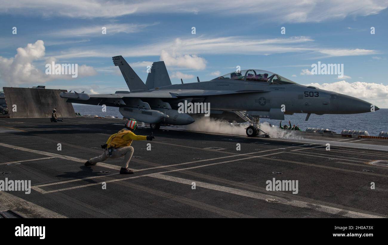 210107-N-CU072-1207     PACIFIC OCEAN (Jan. 7, 2021) – U.S. Navy Lt. Cmdr. Kelly Altschul, a catapult officer, signals the pilot of an EA-18G Growler, assigned to the “Gray Wolves” of Electronic Attack Squadron (VAQ) 142, to take off from the flight deck of the aircraft carrier USS Theodore Roosevelt (CVN 71) Jan. 7, 2021. The Theodore Roosevelt Carrier Strike Group is on a scheduled deployment to the U.S. 7th Fleet area of operations. As the U.S. Navy's largest forward deployed fleet, with its approximate 50-70 ships and submarines, 140 aircraft, and 20,000 Sailors in the area of operations a Stock Photo