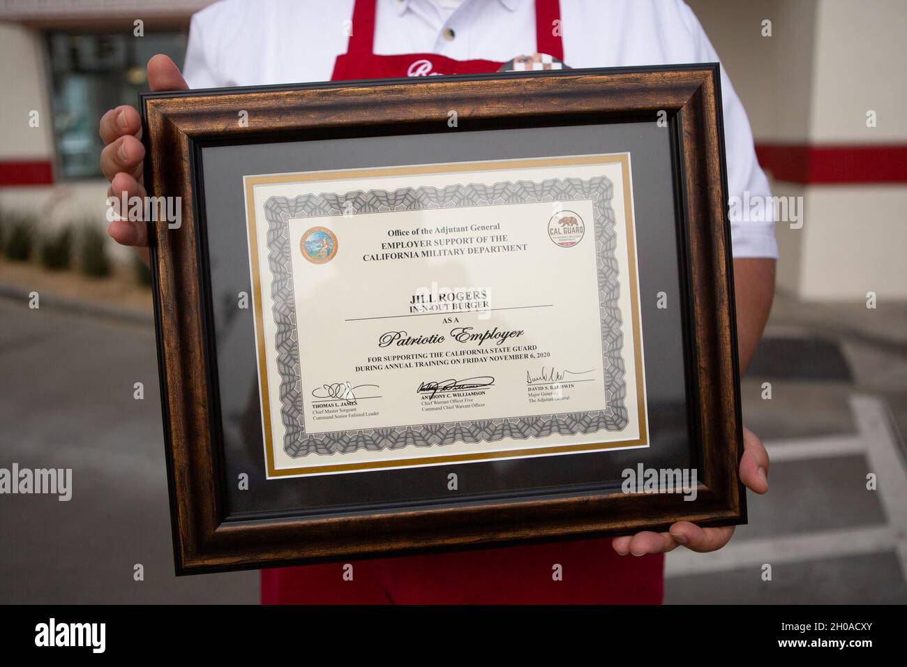 benjamin-corona-an-in-n-out-store-manager-displays-a-patriotic-employer-certificate-presented-to-the-restaurant-by-the-california-military-department-jan-8-2021-in-long-beach-california-in-early-november-an-in-n-out