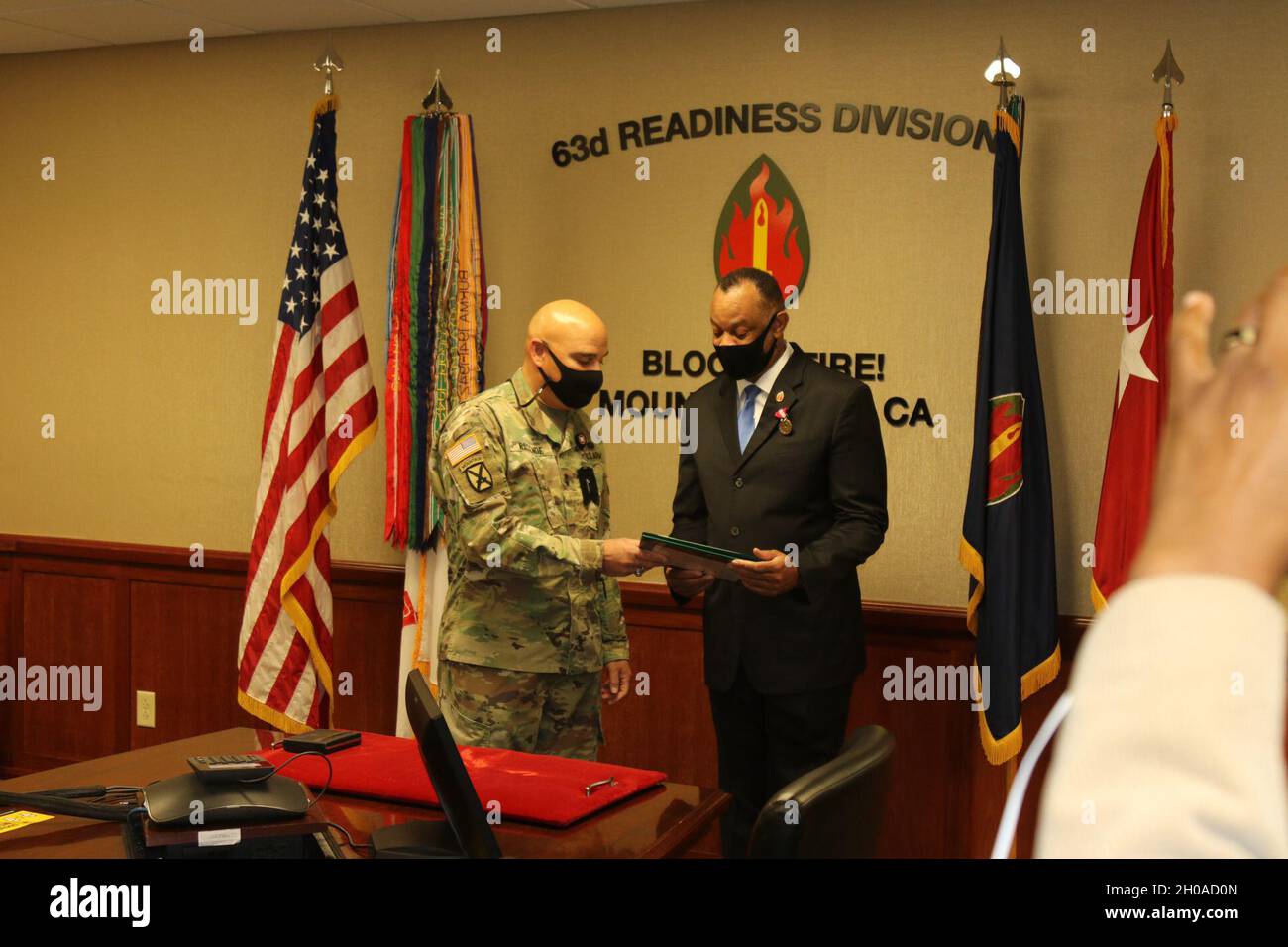 MOUNTAIN VIEW, Calif. - Mr. Kario Harris, civilian, chief of staff, 63d Readiness Division, receives the Meritorious Civilian Service Medal from Maj. Gen. Alberto Rosende, commanding general, 63d RD during 63d RD's Headquarters and Headquarters Detachment's Soldier Virtual Battle Assembly, Jan. 8, 2021. Stock Photo