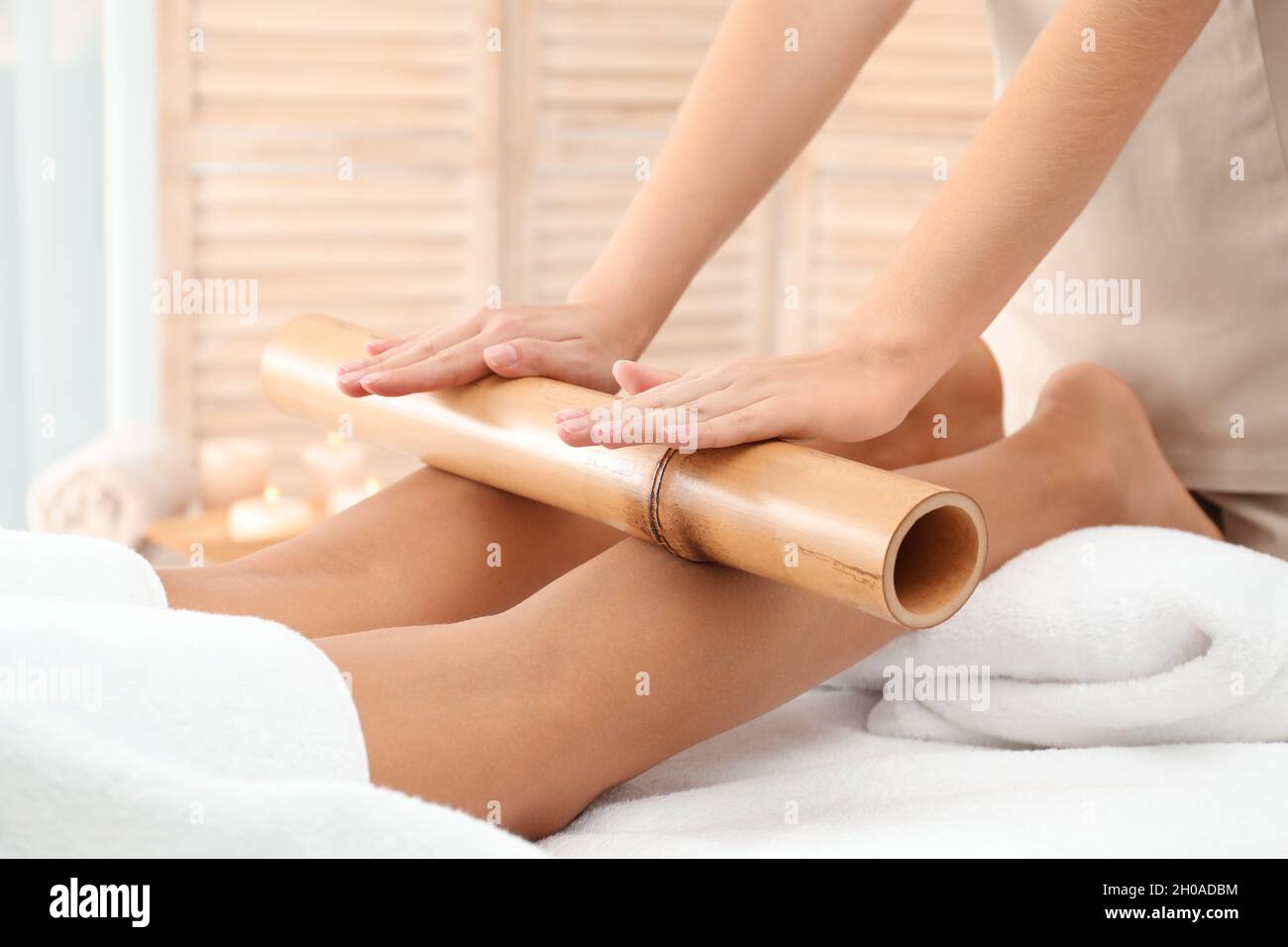 Woman having massage with bamboo stick in wellness center, closeup Stock  Photo - Alamy