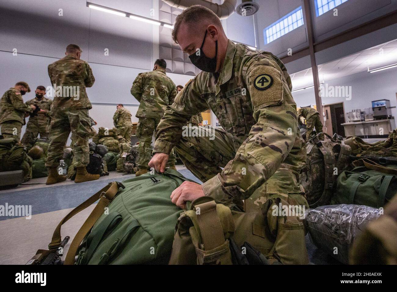 A U.S. Army Soldier with Charlie Company, 1-114th Infantry Regiment, New Jersey Army National Guard, packs his bag at the National Guard Armory at Blackwood, N.J., Jan. 9, 2021. The Soldiers are part of nearly 500 New Jersey Citizen-Soldiers and Airmen deploying to Washington, D.C. The mission is to support the District of Columbia National Guard and local law enforcement, providing security, protection of national monuments, and ensuring the peaceful transfer of power. The mission will last at a minimum until Inauguration Day Jan. 20. In addition to the 114th, Soldiers from the 102nd Cavalry Stock Photo