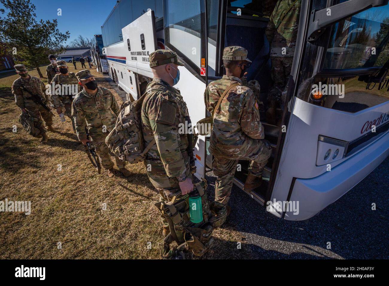 U.S. Army Soldiers with Charlie Company, 1-114th Infantry Regiment, New Jersey Army National Guard, load their backpacks on to a bus at the National Guard Armory at Blackwood, N.J., Jan. 9, 2021. The Soldiers are part of nearly 500 New Jersey Citizen-Soldiers and Airmen deploying to Washington, D.C. The mission is to support the District of Columbia National Guard and local law enforcement, providing security, protection of national monuments, and ensuring the peaceful transfer of power. The mission will last at a minimum until Inauguration Day Jan. 20. In addition to the 114th, Soldiers from Stock Photo