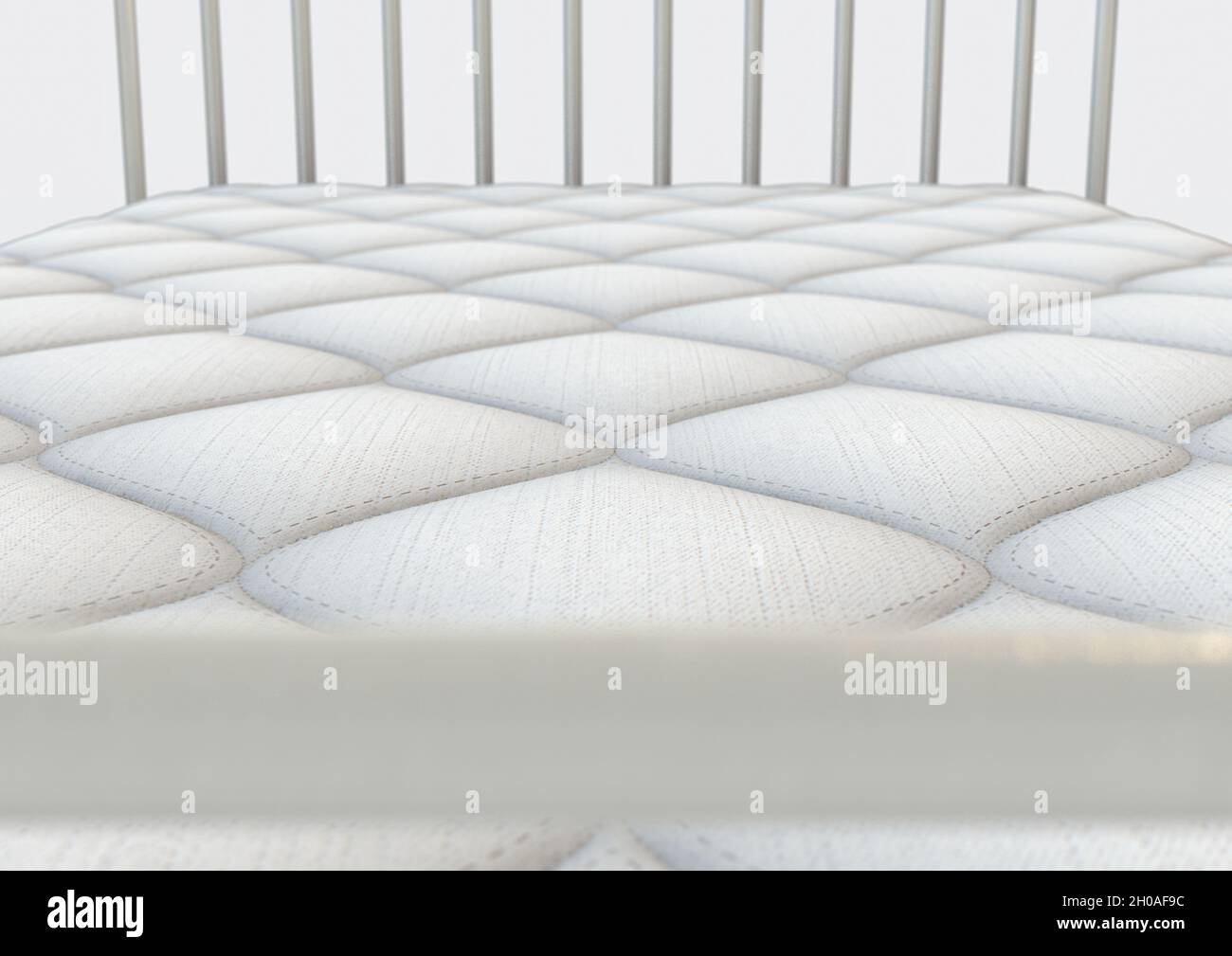 A simple white bed mattress with a decorative topping and fabric sides ...