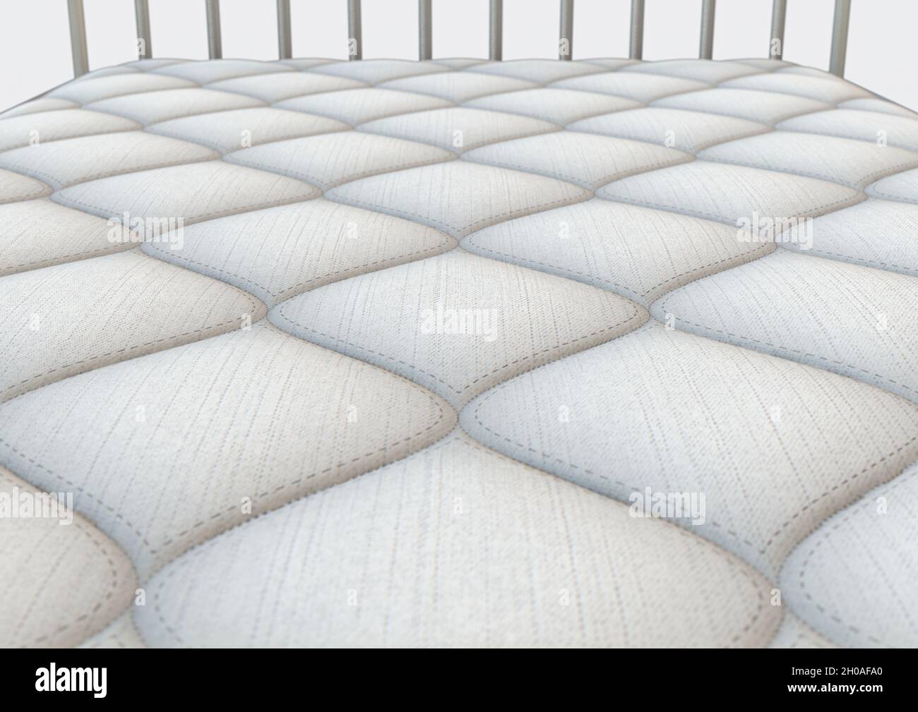 A simple white bed mattress with a decorative topping and fabric sides ...