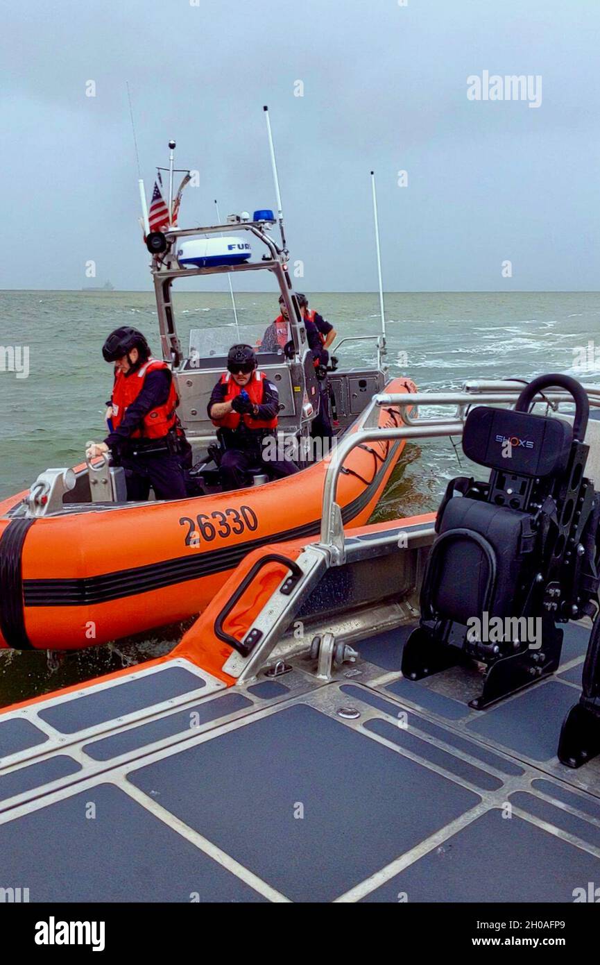 A U.S. Coast Guard small boat crew from the USCGC Stone (WMSL 758) prepares to board another boat from the Stone in a training exercise off Guyana's coast on Jan. 9, 2021. The U.S. and Guyana coast guards worked together to share tactics and methods during the exercise. Stock Photo