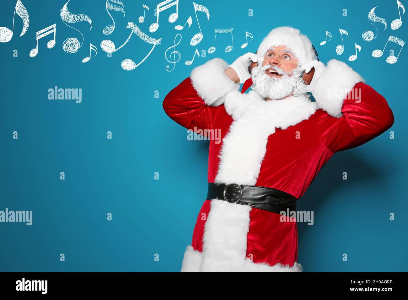 Santa Claus with headphones and music notes on blue background