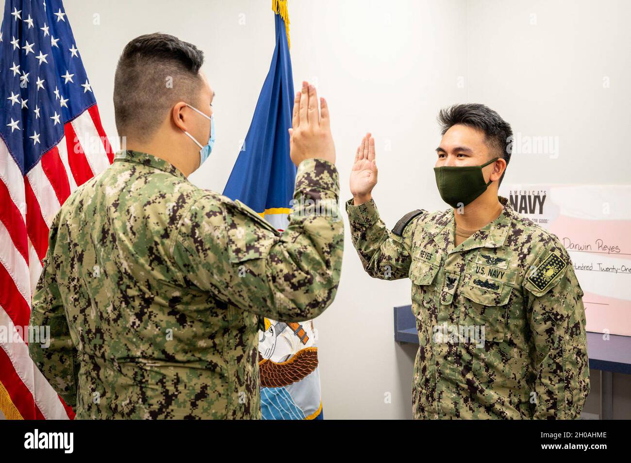 210111-N-WF272-1029 TOWSON, Md. (Jan. 11, 2021) Aviation Boatswain’s Mate (Equipment) 1st Class Darwin Reyes, right, from Fairfax, Va., assigned to Navy Talent Acquisition Group Philadelphia, recites the oath of enlistment given by Lt. Wobin Ko during a reenlistment ceremony held at Navy Talent Acquisition Center Baltimore. Reyes reenlisted for four more years in the Navy. NTAG Philadelphia encompasses regions of Pennsylvania, New Jersey, Delaware, Maryland and West Virginia, providing recruiting services from more than 30 talent acquisition sites with the overall goal of attracting the highes Stock Photo