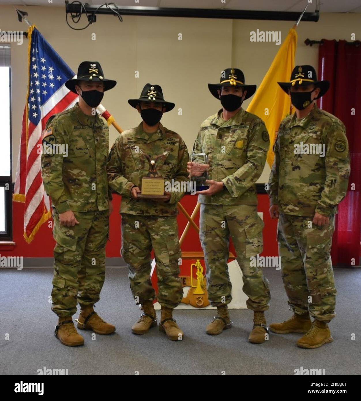 3d Cavalry Regiment Commander, Col. Kevin Bradley and Command Sgt. Maj. present the Regimental Support Squadron Commander, Lt. Col. Danilo Green and Command Sgt. Maj. David Schoettle with Retention Early Bird and the Top Retention Unit Award for 2020 during a presentation on January 8 at Fort Hood, Texas. Stock Photo
